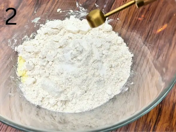 Adding flour to make soft cookie dough