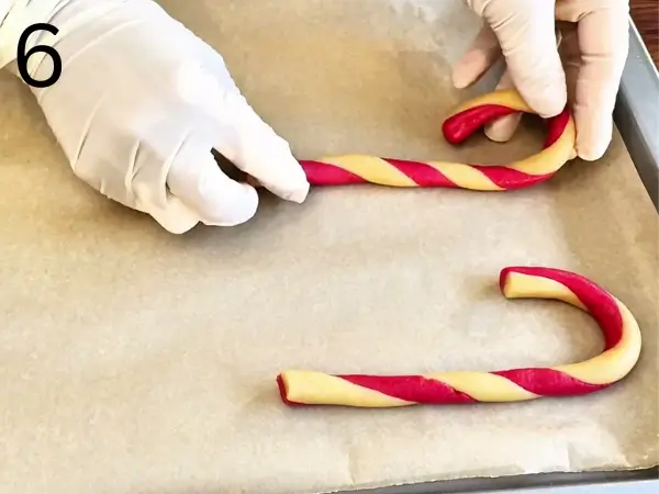 Rolling dough into thin strips for cookies