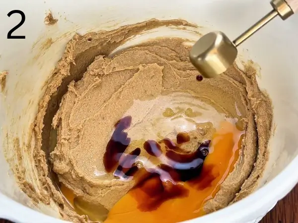 Adding egg and vanilla to chocolate chip cookie dough mixture