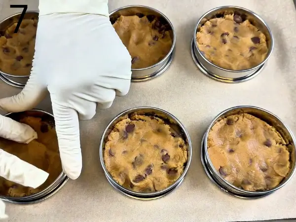 Scooping stuffed chocolate chip cookies dough onto baking tray