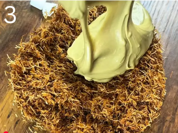 mixing kataifi with pistachio paste and white chocolate