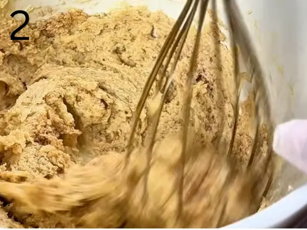 Adding milk and vanilla to the cookie mixture
