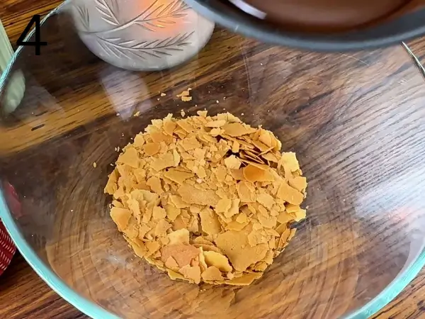 Folding chocolate chips into soft cookie dough
