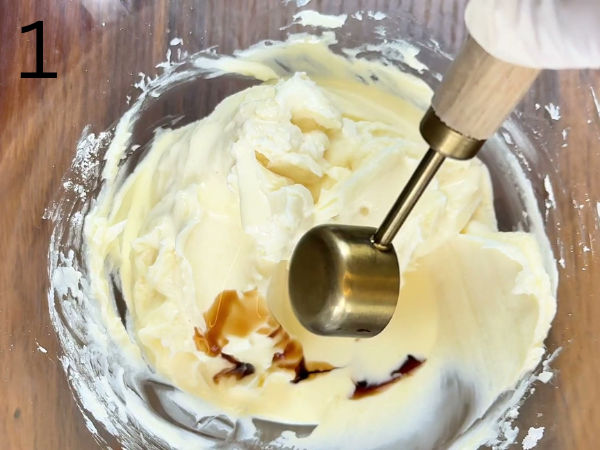 Cream cheese mixture being whipped with powdered sugar until smooth and creamy