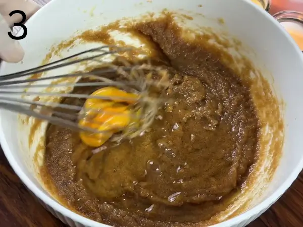 adding egg and vanilla to cookie dough mixture