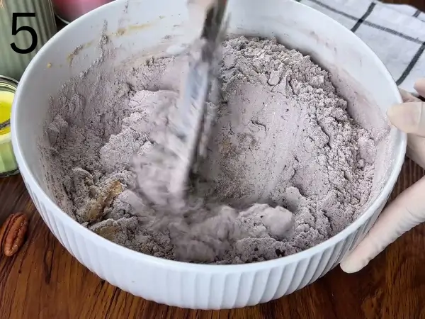 combining wet and dry ingredients into cookie dough