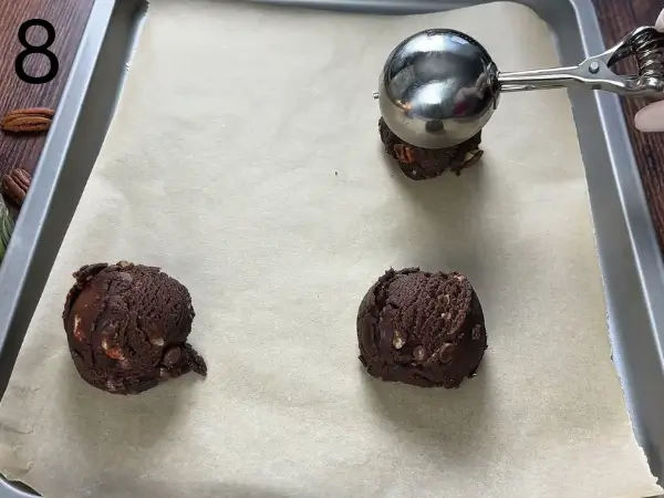 shaping cookie dough balls on baking tray