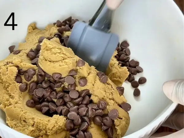 Folding chocolate chips into cookie dough