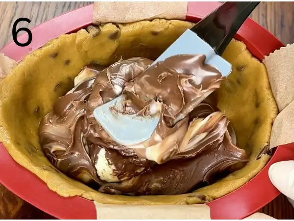 Filling silicone mold with cookie dough and spread