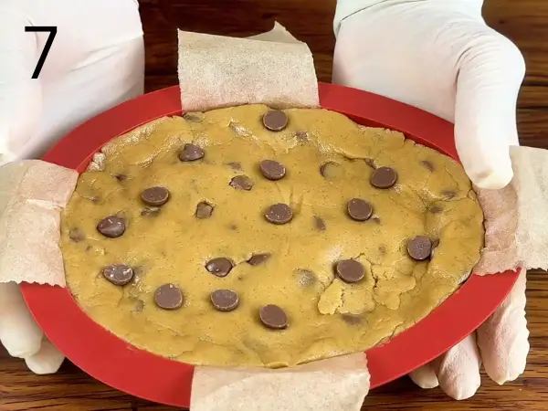 Shaping stuffed cookie dough into egg form