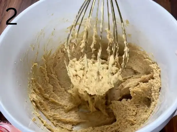 adding egg and vanilla to cookie dough mixture