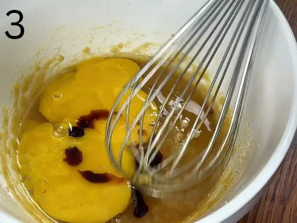 Adding egg and vanilla to cinnamon roll cookies mixture