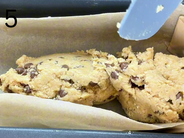 Pressing the dessert mixture evenly into the pan