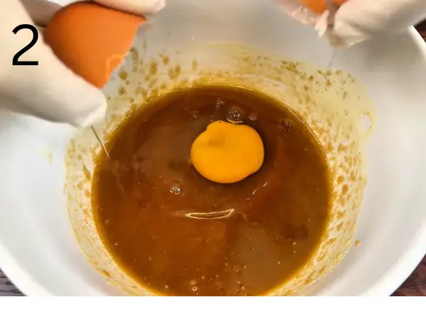 Adding eggs and vanilla to soft stuffed cookie dough