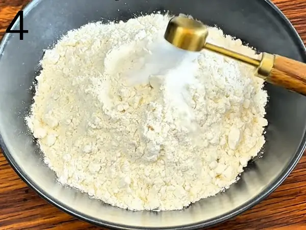 Folding milk chocolate chips and white chocolate chips into cookie dough