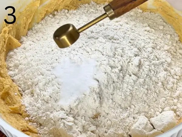 Mixing flour into bakery-style stuffed cookie dough