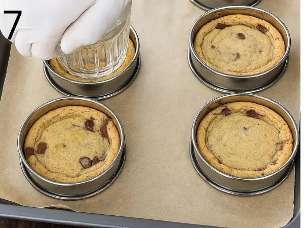 Scooping stuffed cookie dough into round baking molds