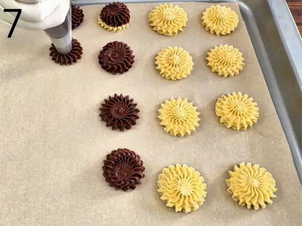 Piping star-shaped cookies onto baking tray
