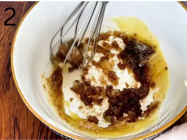 Mixing brown sugar and white sugar with browned butter