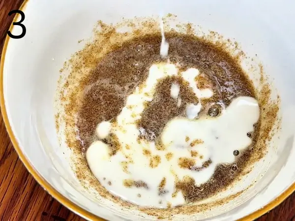 Adding milk and vanilla to the cookie mixture