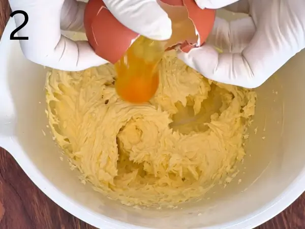 Adding egg to the cookie dough mixture