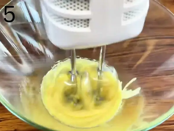 Whisking egg yolks and sugar over a double boiler for the mascarpone filling.