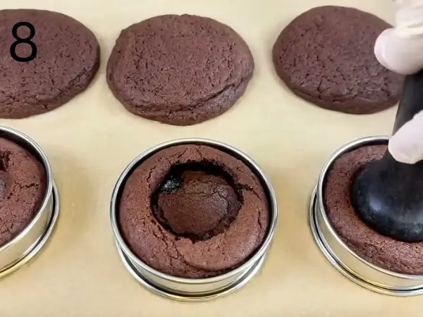 Filling cooled Tiramisu Cookies with mascarpone cream before serving.