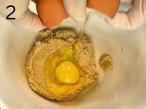 Mixing egg, vanilla, and mashed banana into the cookie dough