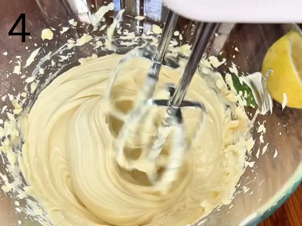 Making creamy cheesecake filling with cream cheese, mascarpone, and lemon