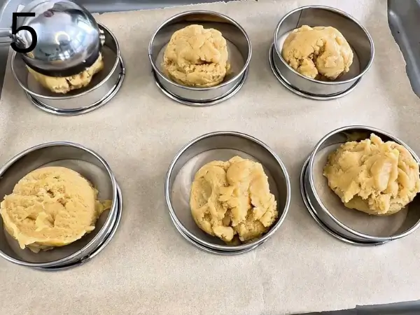 Shaping Lemon Cheesecake Cookies on a baking tray before baking