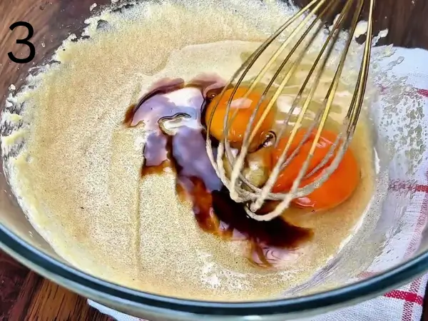 Mixing browned butter with sugar, egg, egg yolk, and vanilla extract.