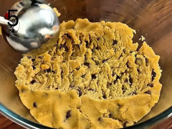 Covering the cookie dough and chilling it in the refrigerator.