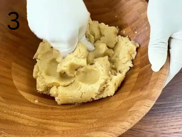 Kneading soft cookie dough by hand until smooth and ready for shaping