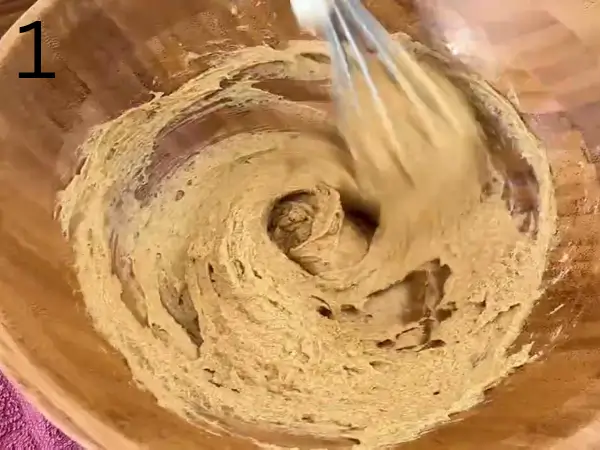 Butter, granulated sugar, and brown sugar being mixed in a bowl until light and creamy for Almond Croissant Cookies.