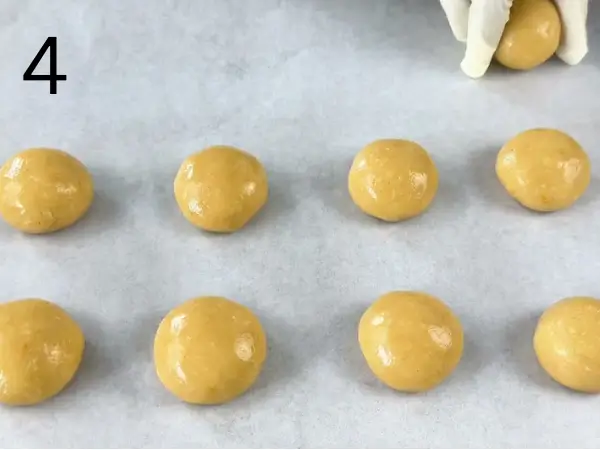 Shaping the dough into small balls for homemade Orange Coconut Cookies