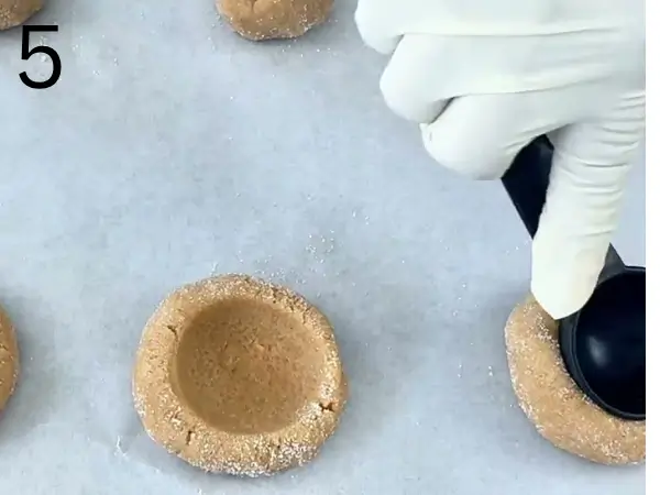 Cookie dough rolled into even balls and coated with sugar before baking.