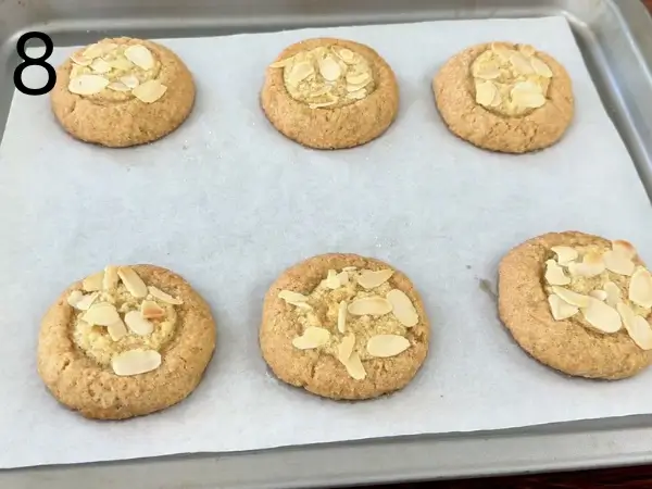 Freshly baked Almond Croissant Cookies cooling on a baking tray until lightly golden and ready to serve.